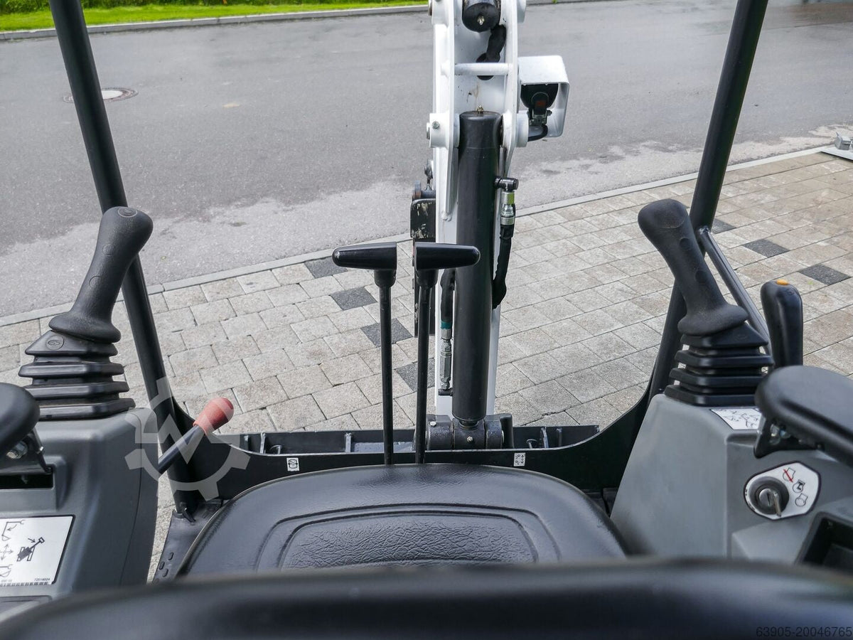 Vue depuis le poste de conduite de la mini-pelle Ma boutique Bobcat E17 montrant les commandes et le bras articulé