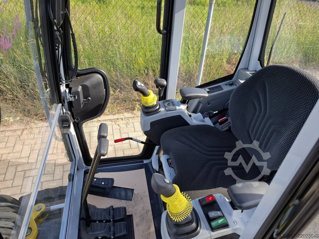 Intérieur de la cabine de la mini-pelle Ma boutique Wacker Neuson ET24 avec siège ergonomique et joysticks de contrôle